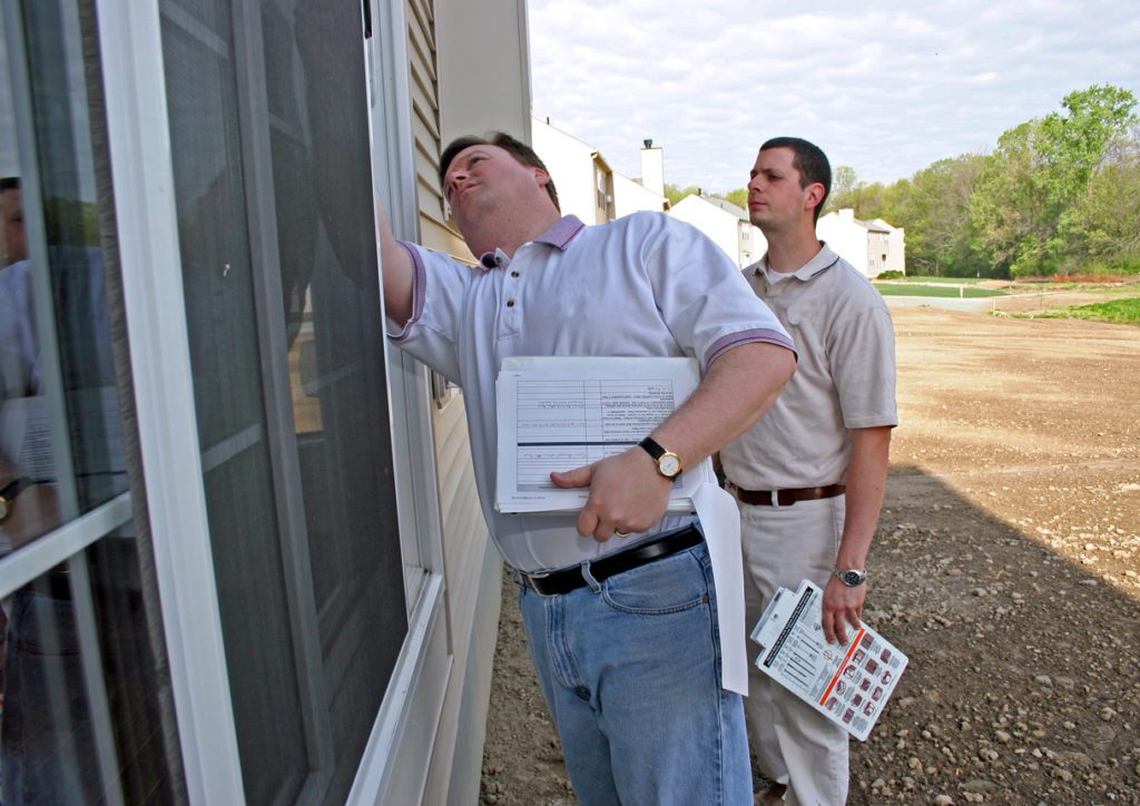 home appraisal with two men inspecting windows