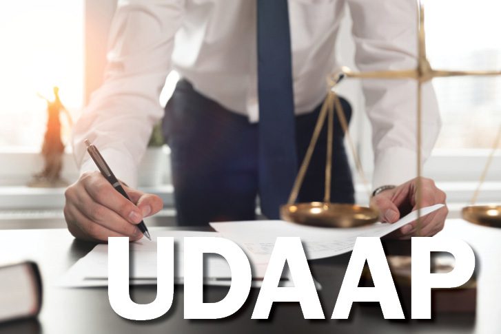 udaap-reviews person sigining document with udaap text overlay
